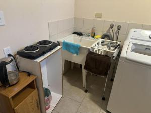 a small kitchen with a sink and a stove at Sweet 1 bed room, for female only in Ottawa