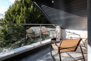 a balcony with two chairs on a deck at Cozy Studio Flat in Coulsdon, CR5 in Coulsdon
