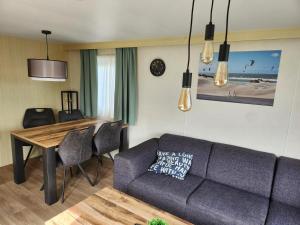 a living room with a couch and a table at Camping Duin en Strand in Scharendijke