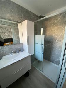 a bathroom with a sink and a shower at Villa Panorama in Uzès