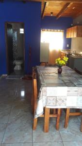 a kitchen with a table and a sink and a toilet at LAPACHO II in Puerto Leoni
