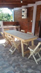 a wooden picnic table and chairs in a patio at LAPACHO II in Puerto Leoni