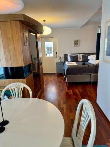 a living room with a bed and a table and chairs at Hills Cottage in Gränna