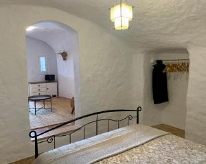 A bed or beds in a room at Cueva Romana Cave House, Clothing Optional, Adult Only