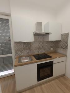 a kitchen with a sink and a stove top oven at La Casa di Ary in Cisterna di Latina