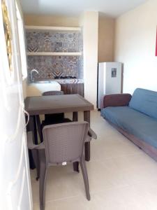 eine Küche mit einem Waschbecken, einem Tisch und einem Sofa in der Unterkunft Casa Marcella in Playa Dormida