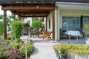 a patio with a table and chairs on it at Ferienwohnung Noll in Alzenau in Unterfranken