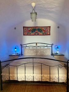 A bed or beds in a room at Cueva Romana Cave House, Clothing Optional, Adult Only