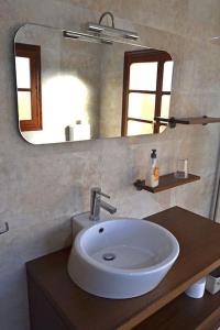 a bathroom with a white sink and a mirror at Casa Manuela LLanes Asturias. in Pendueles +16 photos