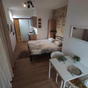 a small bedroom with a bed and a table at Studio apartment with sea view in Sali