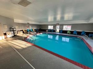a large swimming pool in a hotel room at AmericInn by Wyndham Reedsburg in Reedsburg