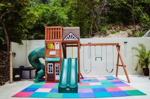 a playground with a slide and a play structure at Nirú Ocean Suites by Binniguenda in Santa Cruz Huatulco
