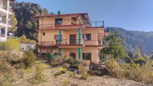 a house on the side of a hill at Hira Homestay in Bhowāli