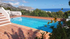 a swimming pool with a view of the ocean at Casa Alberto - Altea in Altea