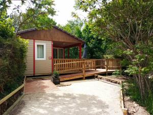 a small cabin with a porch and a deck at Les Chalets d'Argentouleau in Sarlat-la-Canéda