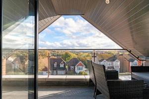 a large glass window in a house with houses at Refined Living: Three Bedrooms Flat in Coulsdon CR5 in Coulsdon