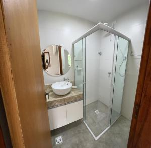 a bathroom with a sink and a mirror at Casa Maritaca in Paraty
