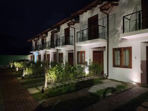 a white house at night with lights at Casa Maritaca in Paraty