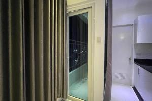 a room with a window with a view of a kitchen at Sheryll Updates - Kandi T2 breezy 1BR on 9th floor with Housekeeping & Netflix in Angeles