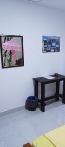 a room with a table and a picture on the wall at KANTHI GUEST INN in Trincomalee
