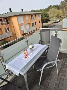 a white table and chairs on a balcony at Strandperle in Ueckeritz