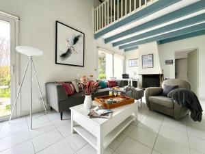 a living room with a couch and a table at Villa de la Cible in Saint-Martin-de-Ré +25 photos