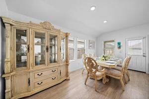 a dining room with a table and a large wooden cabinet at Sa Rancho La Mission Getaway Wi-fi Yard Bbq in Elmendorf