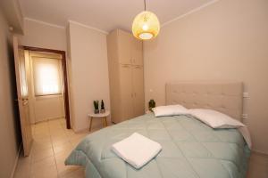 a bedroom with a large bed and a light fixture at John & Angelo Villa in Akrotiri +43 photos