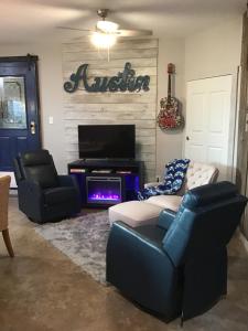 a living room with a couch and a tv at Big Red Cactus - Austin Accommodations in Austin