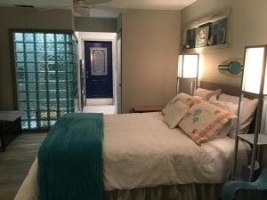 a bedroom with a bed and a blue door at Big Red Cactus - Austin Accommodations in Austin