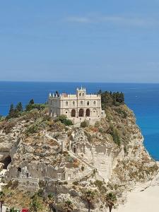 um castelo no topo de uma montanha perto do oceano em Rita's House em Bivona