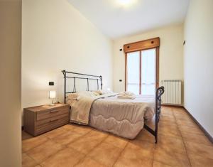 a bedroom with a bed and a dresser and a window at Residenza Il Centro in Brivio
