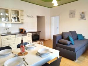a kitchen and living room with a table and a couch at Ferienzimmer Reinisch in Tattendorf in Tattendorf