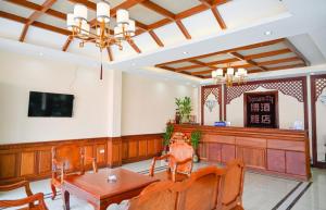 a lobby with a table and chairs and a television at Thavixay Hotel 博雅酒店酒店 in Vientiane