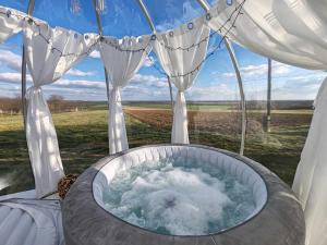 a tub in a tent with water in it at Buby - végtelenbe és tovább in Szigetvár