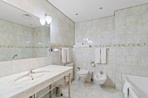 a bathroom with a sink and a toilet at Hotel Schild in Vienna