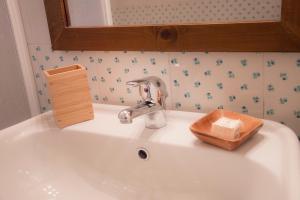 a bathroom sink with a faucet and a wooden box at Iscairia Country House in Ascea