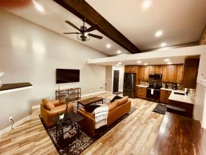 a living room with two couches and a kitchen at Iona Mercantile BnB in Rigby