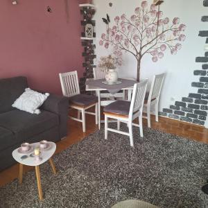 Mila في Kaštel Novi: غرفة معيشة مع أريكة وطاولة وكراسي