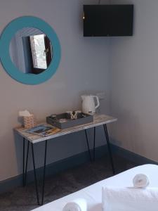 a table in a room with a mirror at Friars Bridge Guesthouse in Inverness