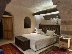a bedroom with a large bed in a building at Kistar Cave Hotel in Uçhisar