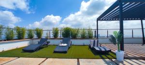 a patio with chairs and a table on a roof at Top Tier Home in Nairobi
