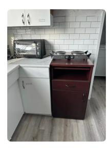 a kitchen with a stove top oven in a kitchen at Spotless 2 Bedrooms Suite 2 in Winnipeg in Winnipeg