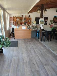 a large room with a wooden floor and a counter at Camping la Vallée in La Tour-dʼAuvergne