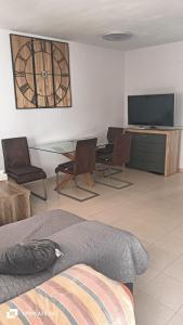 a living room with chairs and a table and a television at Chalet de la playa in Oropesa del Mar