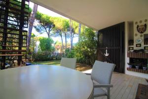 a dining room with a table and two chairs at Villaggio Estate in Lignano Sabbiadoro