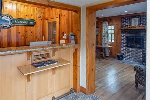 a kitchen with a counter and a fireplace in a house at The Ridgeway Inn in Blowing Rock