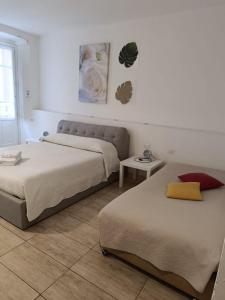 a bedroom with two beds and a table at AL183 in Cagliari