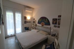a bedroom with a bed and a window at Villaggio Estate in Lignano Sabbiadoro +69 photos