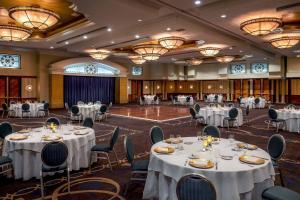 a banquet hall with white tables and chairs and chandeliers at Sheraton Pentagon City in Arlington